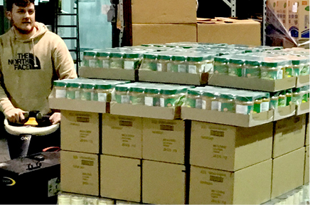 HHFB employee with boxes of food